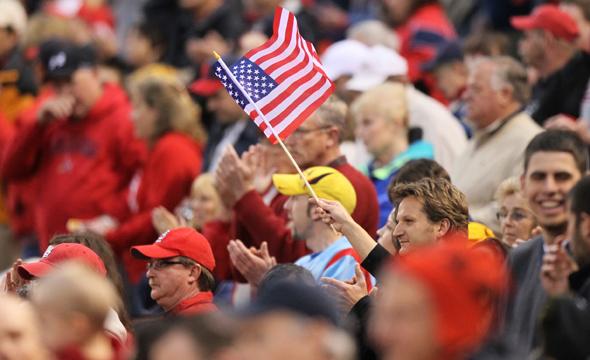 A fan waves an American flag at Busch Stadium before the singing of the National Anthem as the public announcer describes the events of the past 24 hours including the death of Osama bin Laden. The St. Louis Cardinals faced the Florida Marlins on Monday, May 2, 2011, in St. Louis, Missouri. (Chris Lee/St. Louis Post-Dispatch/MCT)