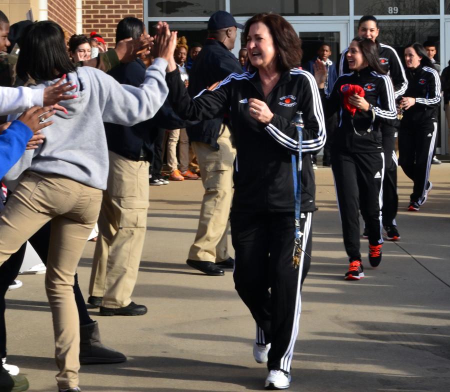 Coach Self-Morgan high fives fans as she heads to the bus for the state tournament (Tricia Virtue)