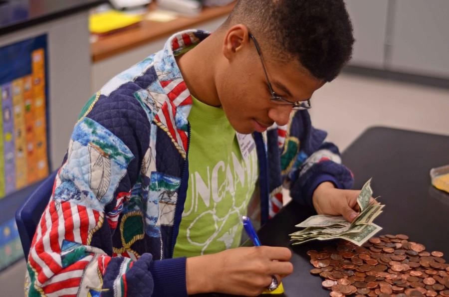 Student Council representatives count pennies and dollars at the conclusion of their fundraiser fo leukemia. (Leenolia Robinson photo)
