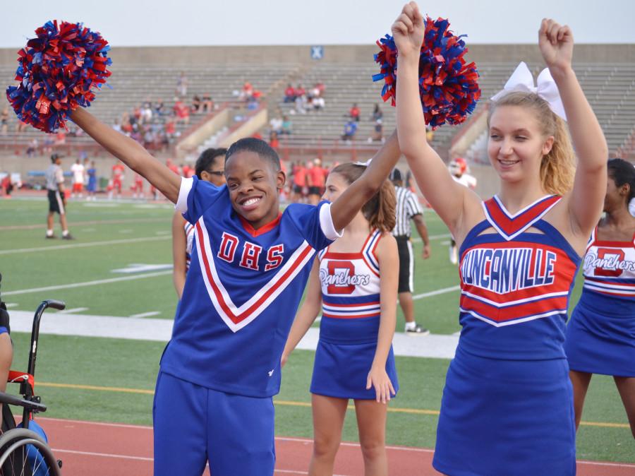 Damion  Jordon dances to a cheer with a varsity cheerleader at a junior varsity game.  Jordan has Autism but comes out of his shell when he is on the field or at a pep rally as a Sparkler cheerleader. (Mireya Ibarra photo)