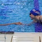 Senior Maddison Samples reaches across the lane to congratulate the second place finisher in her race at the District 7-5a meet after she took the gold medal in the 50 freestyle. (Raquel Mejia photo)