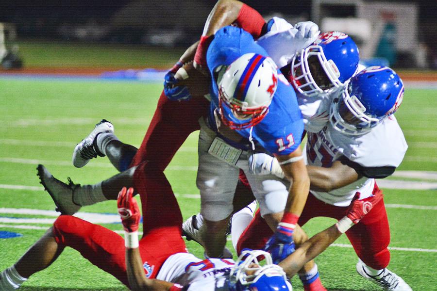 A host of Duncanville defenders wrapup Waco Midways top running back in a close 42-36 game. (Karla Estrada photo)