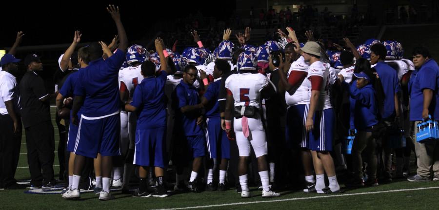 The players huddle up and go in for a high-five, releasing their must. (Tomica Charles photo)