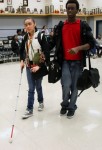 Junior Davion Smith assist Emily Campos through the choir room.  Emily has been blind since birth and Davion has been friends with her for many years. (Karla Estrada Photo)