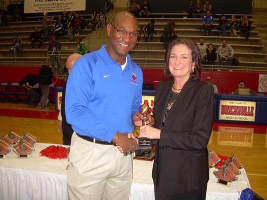 Dr. Alfred Ray presents a trophy to Coach Cathy Self Morgan at the Sandra Meadows Classic. (Karla Estrada Photo)