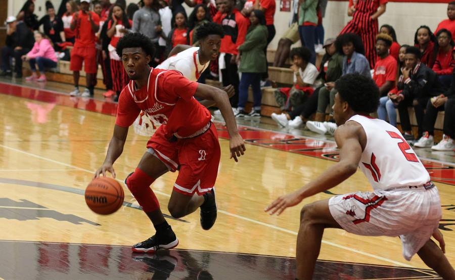 Duncanville player drives in paint as he is loosely guarded by a Cedar Hill player. (photo by: Ricardo Martin)