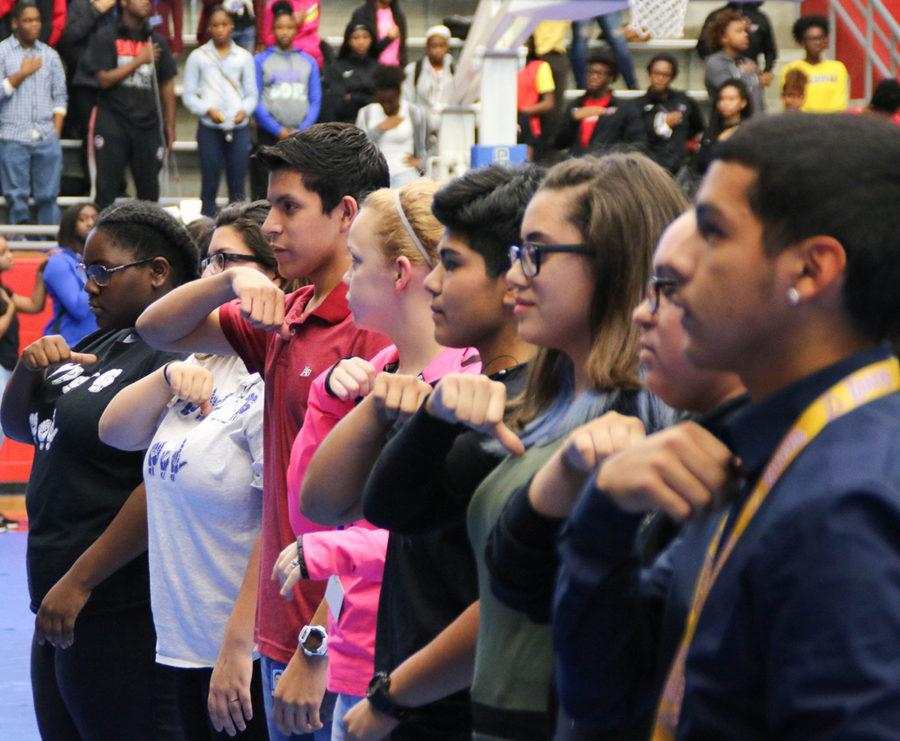Students from ASL club sign the National Anthem during a recent pep rally. (Photo by Emlyn Almanza)