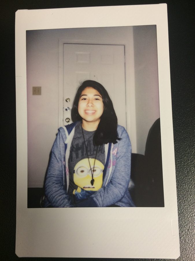 Alondra Gonzales takes a snapshot with a Polaroid while visiting a friends house. 
