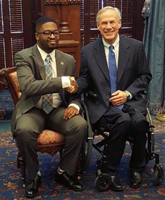 Sharif Long sits and visits with Governor Greg Abbott who is also a graduate from Duncanville. (Diane Williams photo)