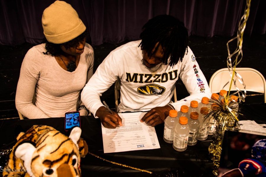 Senior Stacy Brown with his mother signing his letter of intent to Missouri. 