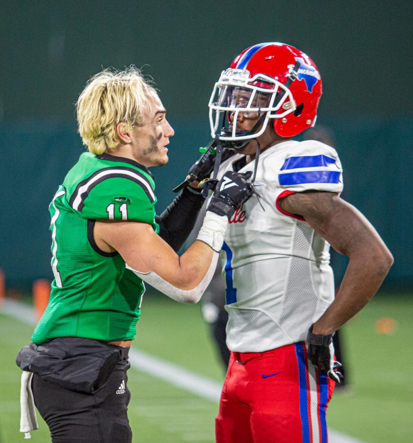 Southlake player Josh Spaeth (11) consoles Chris Hicks Jr. (1) following the Dragons defeat of Duncanville.