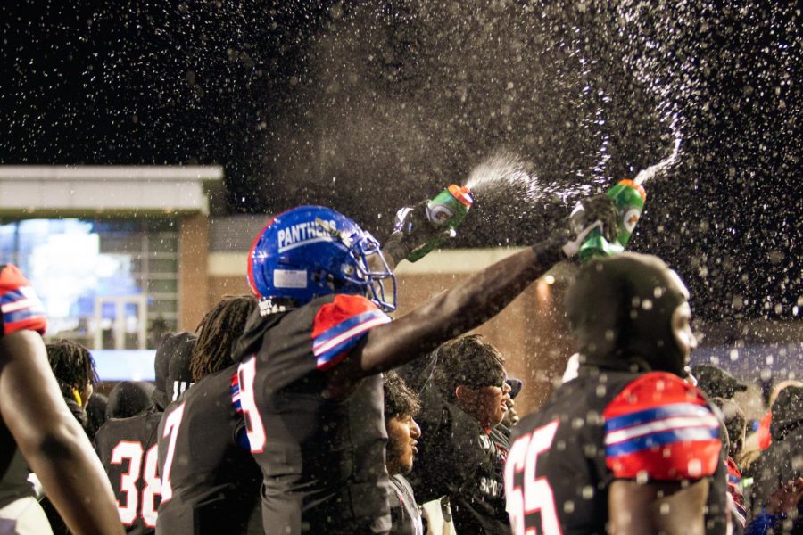 Colin Simmons (8) celebrates by throwing water in the air after the panthers defeated southlake carrol in a rematch of last years state semi final game. 
